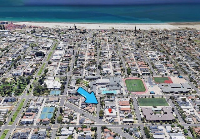 birds eye view of property with a view of the beach and a water view