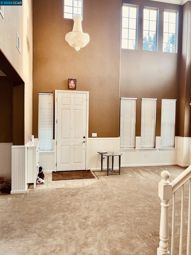 entrance foyer featuring light carpet and a high ceiling