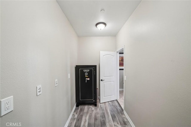 hallway with light hardwood / wood-style floors