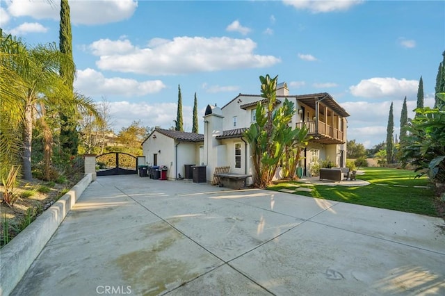 rear view of property with cooling unit, a patio area, and a yard