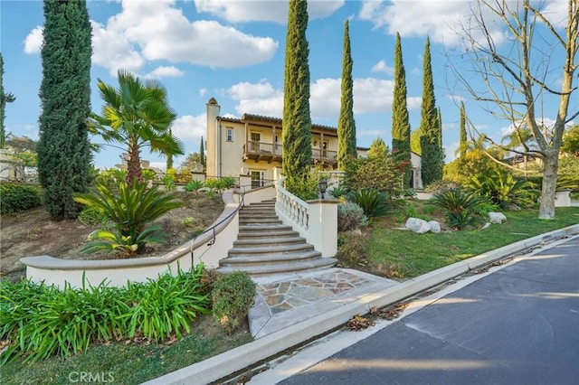 mediterranean / spanish-style home with a balcony