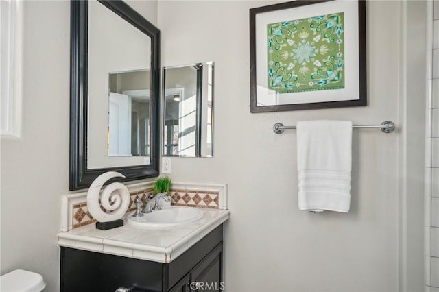 bathroom featuring toilet and vanity