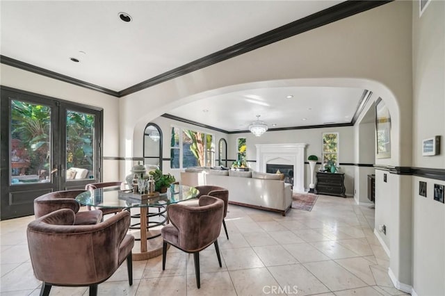 dining space with light tile patterned floors, a wealth of natural light, crown molding, and french doors