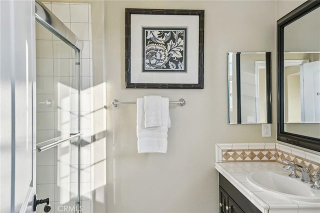 bathroom with an enclosed shower and vanity