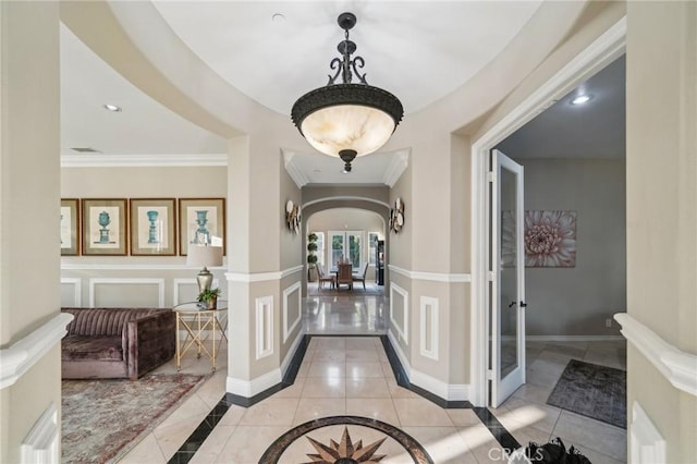 hallway with french doors, light tile patterned flooring, and ornamental molding