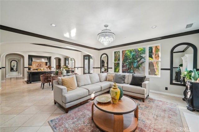 tiled living room with ornamental molding and a notable chandelier