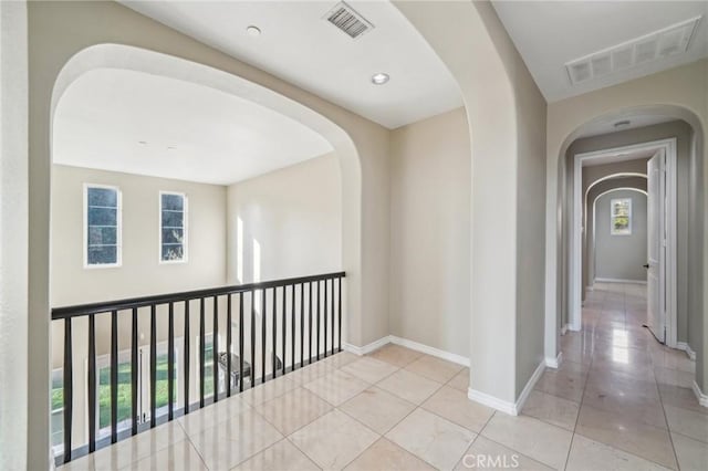 corridor with light tile patterned flooring