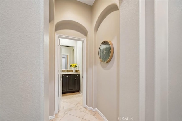 corridor with light tile patterned flooring