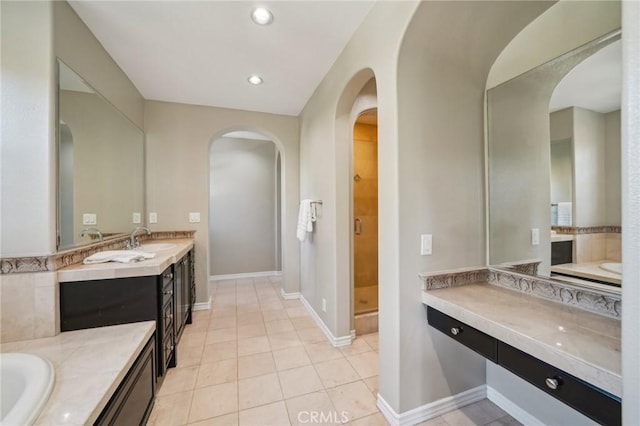 bathroom with a shower, tile patterned floors, and vanity