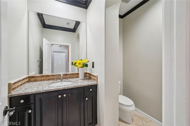 bathroom with toilet, vanity, tile patterned flooring, and crown molding