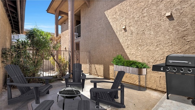 view of patio featuring a grill and an outdoor fire pit