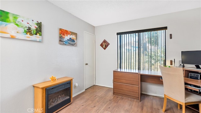 home office with hardwood / wood-style floors