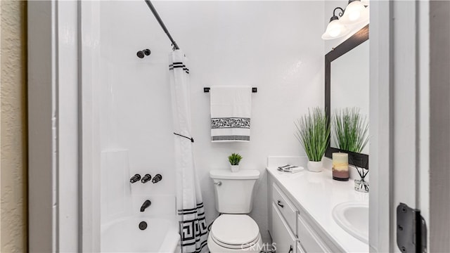 full bathroom with vanity, shower / tub combo, and toilet