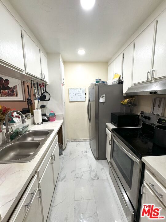 kitchen featuring white cabinetry, sink, and stainless steel appliances