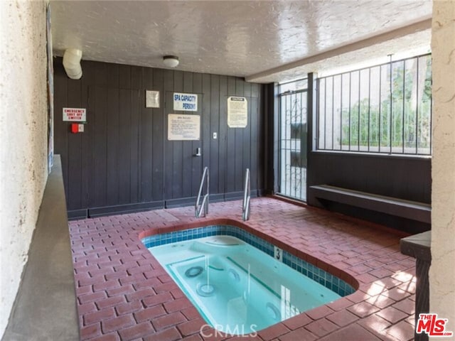 view of pool with an indoor hot tub