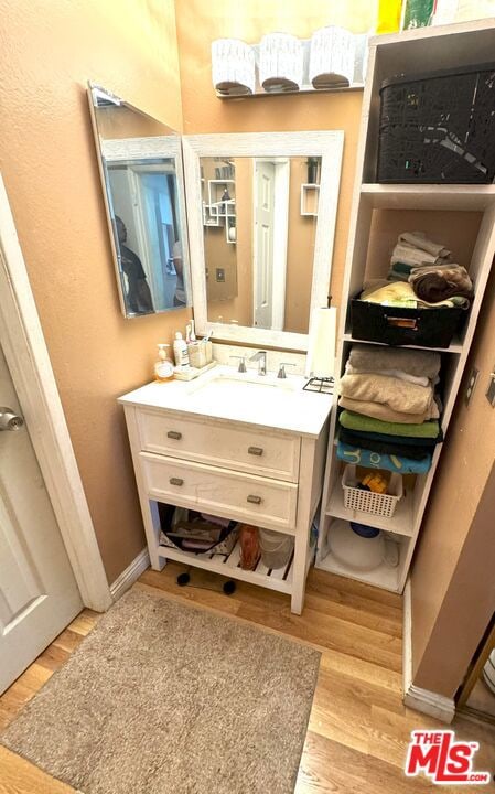 bathroom featuring vanity and hardwood / wood-style flooring