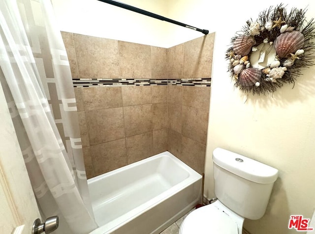 bathroom with shower / tub combo with curtain and toilet