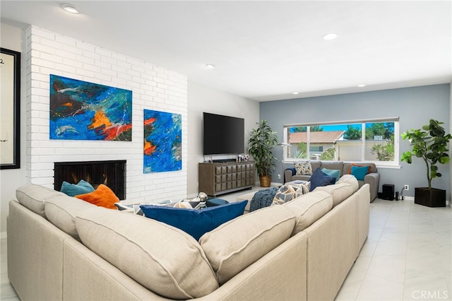 tiled living room with a brick fireplace