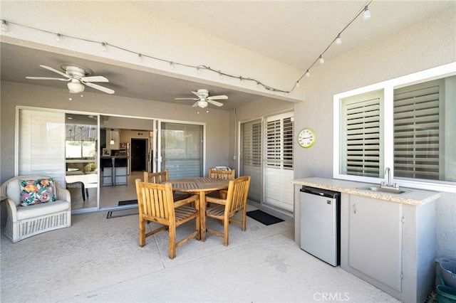 view of patio / terrace featuring sink and ceiling fan