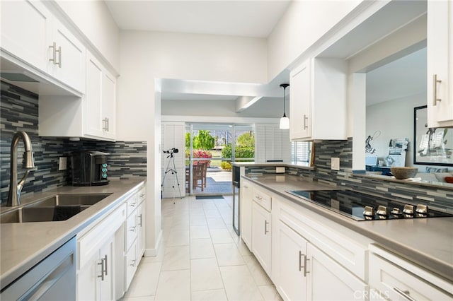 kitchen featuring black electric cooktop, tasteful backsplash, white cabinets, dishwasher, and sink