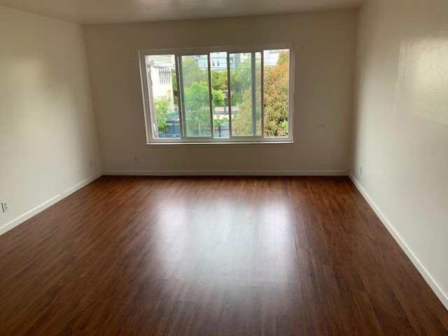 spare room featuring dark hardwood / wood-style flooring