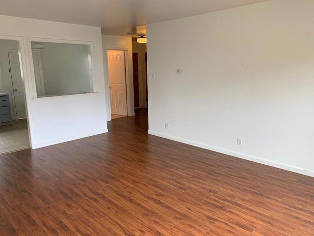 spare room with dark wood-type flooring