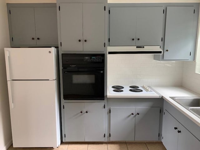 kitchen with white appliances, light tile patterned flooring, tasteful backsplash, and sink