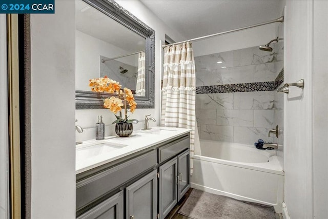 bathroom with shower / tub combo with curtain and vanity