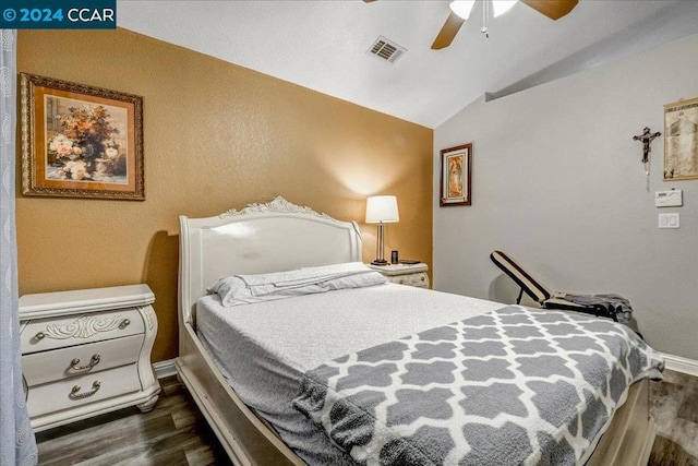 bedroom featuring ceiling fan, lofted ceiling, and dark wood-type flooring