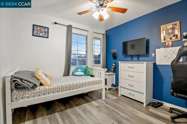 bedroom featuring ceiling fan and light wood-type flooring