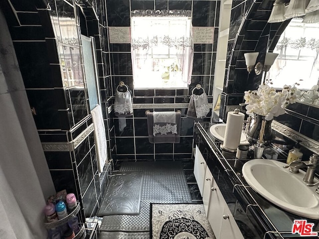 bathroom featuring tile walls, tile patterned floors, and vanity