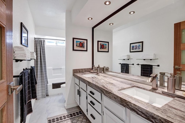 full bathroom with vanity, toilet, and shower / bath combo with shower curtain