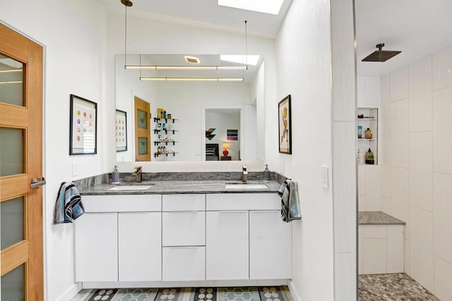 bathroom with tile patterned floors, vanity, tiled shower, and vaulted ceiling