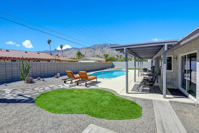 view of pool with a mountain view and a patio area