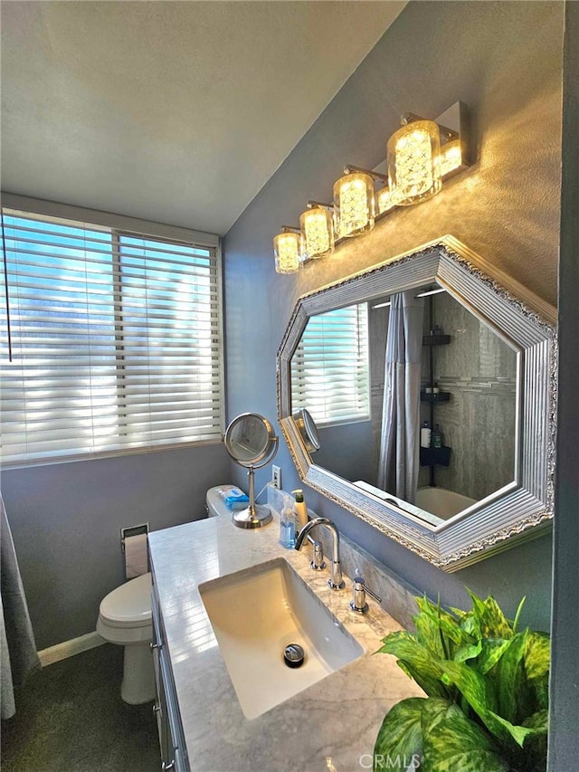 full bathroom with a wealth of natural light, vanity, lofted ceiling, and toilet