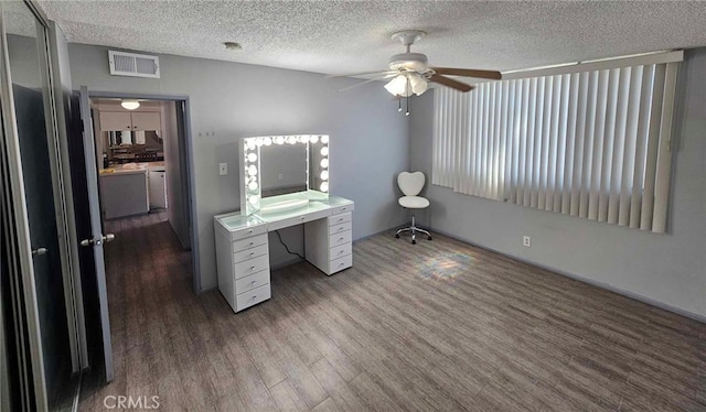 home office with ceiling fan, wood-type flooring, and a textured ceiling