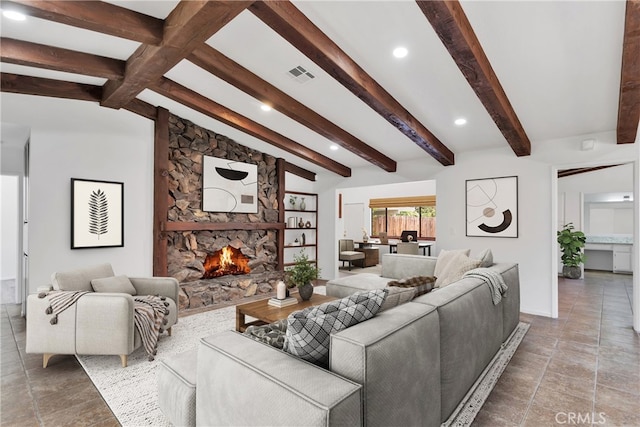 living room featuring vaulted ceiling with beams and a fireplace