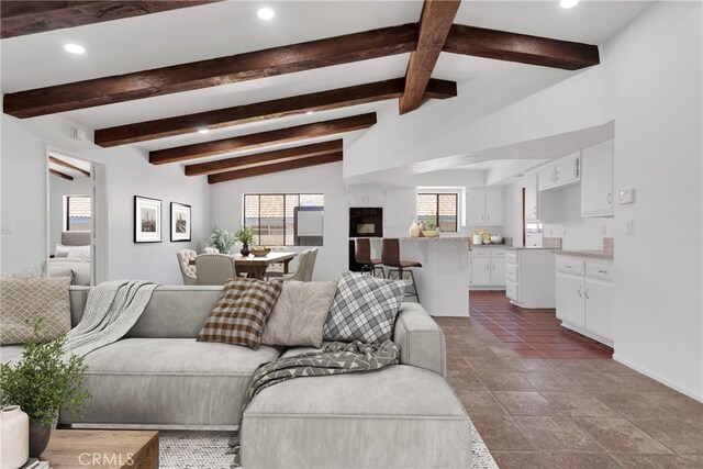 living room with vaulted ceiling with beams