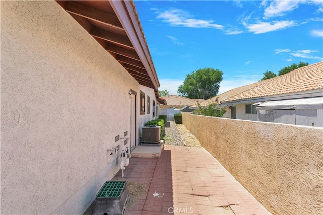 view of home's exterior featuring a patio and central air condition unit