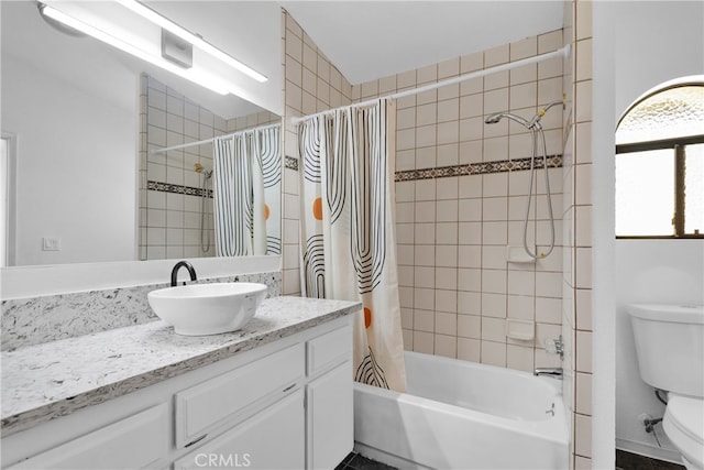 full bathroom featuring shower / bath combo, vanity, and toilet