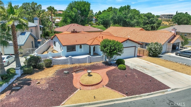 mediterranean / spanish home featuring a garage