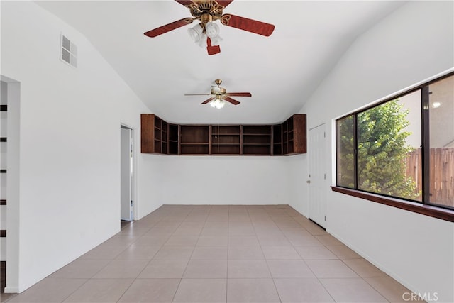 tiled empty room featuring ceiling fan and high vaulted ceiling