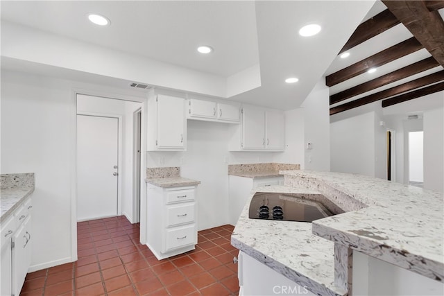 kitchen featuring beam ceiling, white cabinets, tile patterned flooring, and black electric cooktop