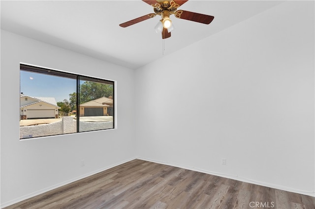 unfurnished room with hardwood / wood-style floors and ceiling fan