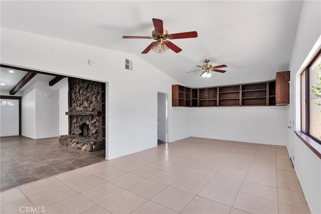 unfurnished living room featuring lofted ceiling, ceiling fan, and a stone fireplace