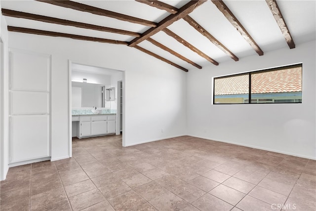 tiled empty room with lofted ceiling with beams