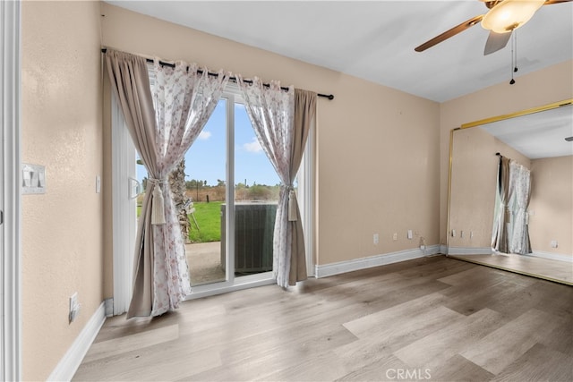 spare room with light hardwood / wood-style flooring and ceiling fan