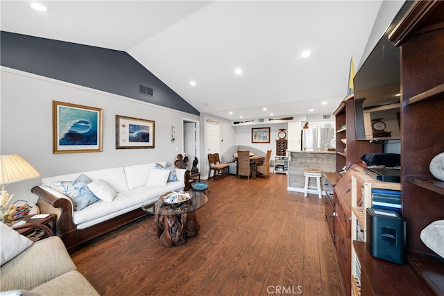 living room featuring lofted ceiling and hardwood / wood-style floors