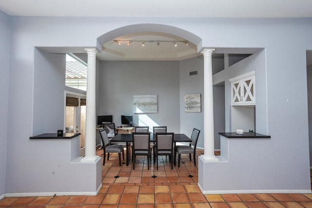 tiled dining room with rail lighting