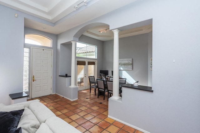 tiled entrance foyer featuring a raised ceiling